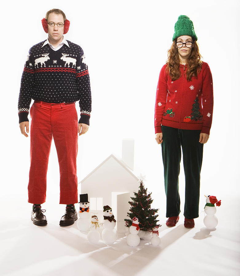 Studio portrait of man and woman in holiday sweaters with Christmas set #2 Photograph by HollenderX2