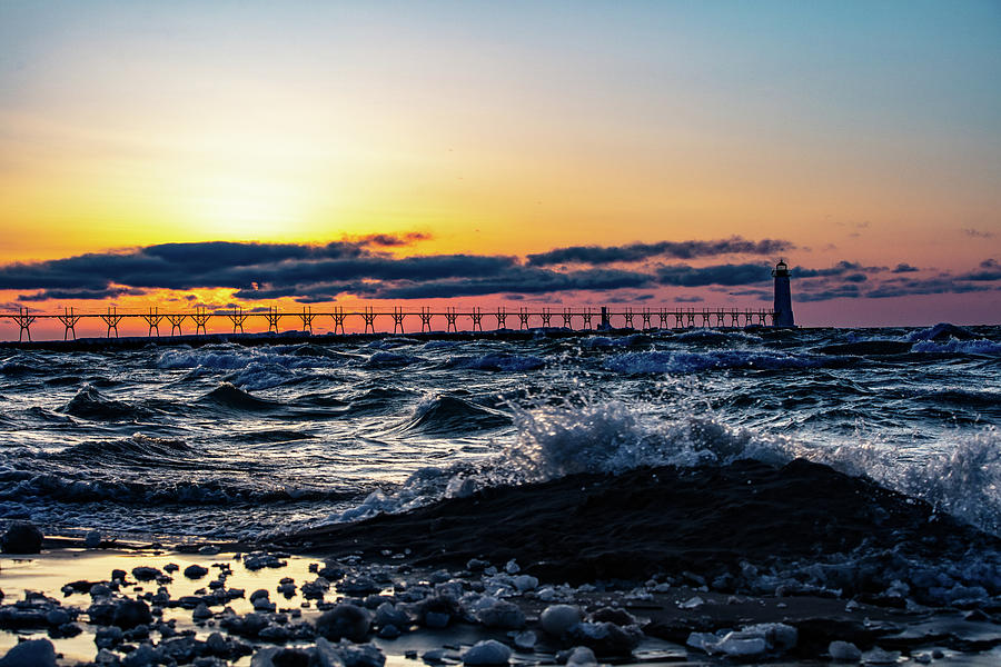 Sunset at Manistee Pier and Lighthouse in Manistee Michigan during the winter #2 Photograph by Eldon McGraw
