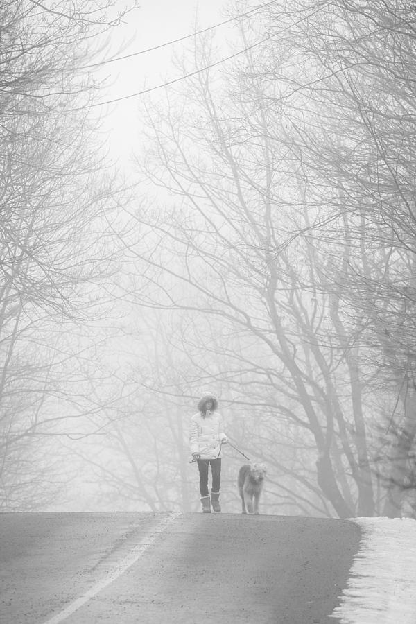 Teenager girl walking dog in the haze #2 Photograph by Alex Potemkin