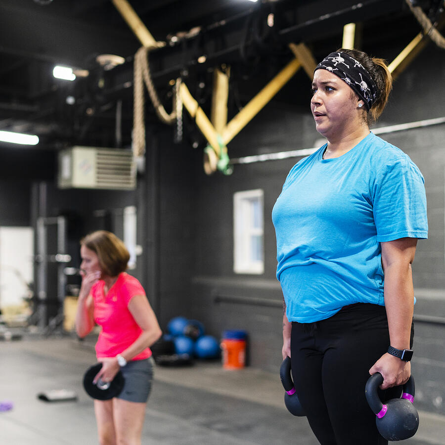 The young, body-positive Latino woman doing step-up with weight exercise in the gym #2 Photograph by Alex Potemkin