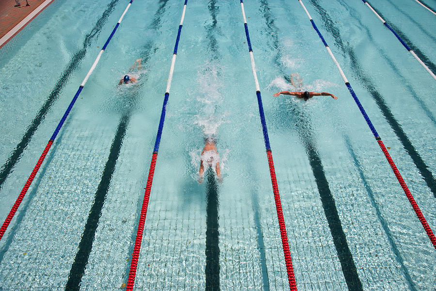 Three swimmers swimming in a pool #2 Photograph by Robert Daly