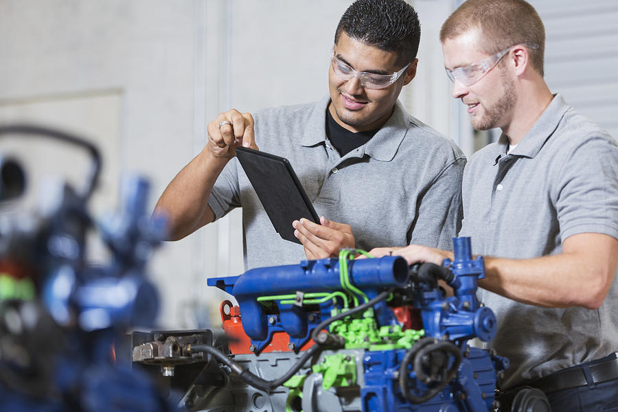 Two multi-racial men in auto mechanic school with engine #2 Photograph by Kali9