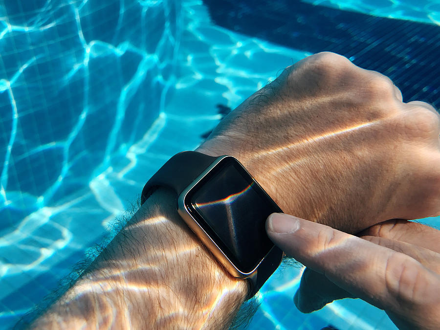 Using smart watch in the swimming pool underwater #2 Photograph by Alexander Spatari