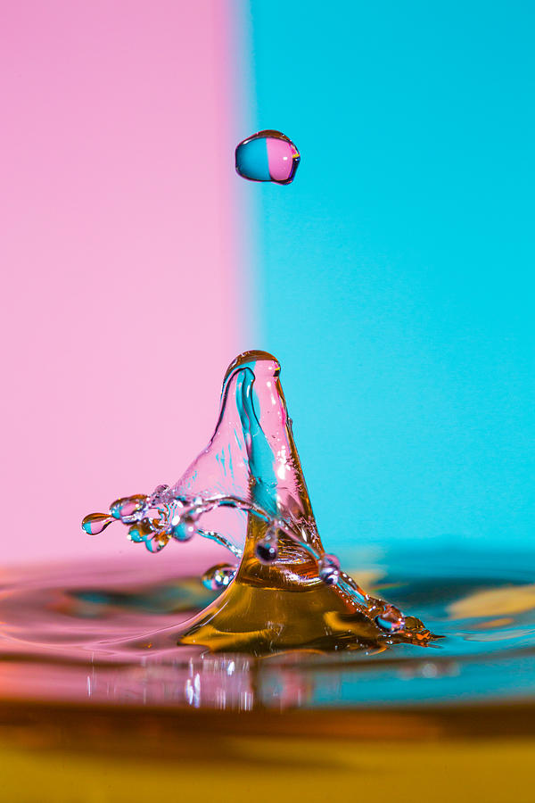 Water Drip on a pink and blue striped backdrop #2 Photograph by Robbie Goodall