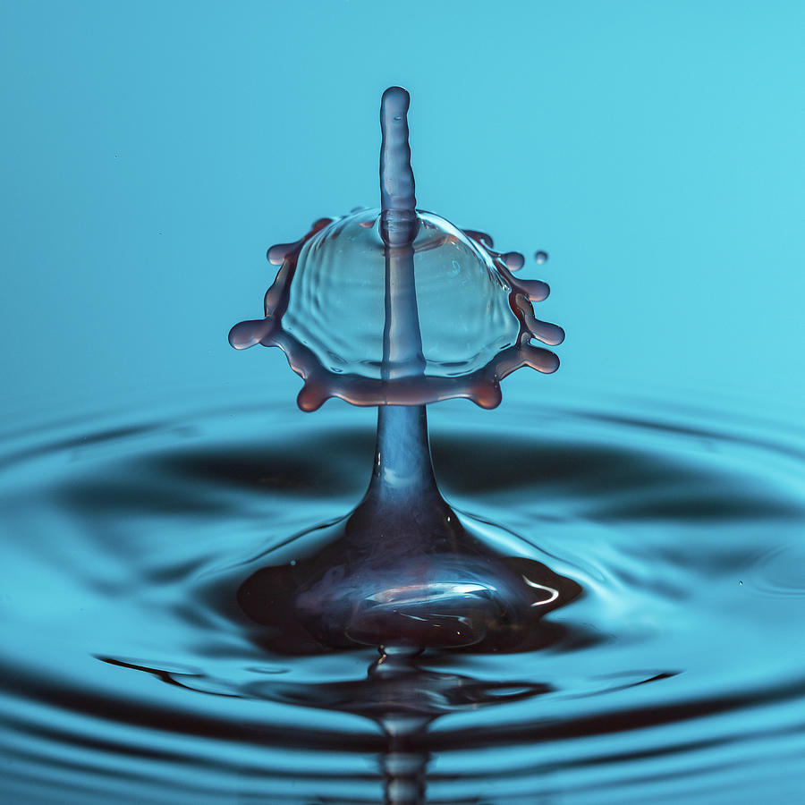 Water drop falling onto column of water Photograph by Steven Heap
