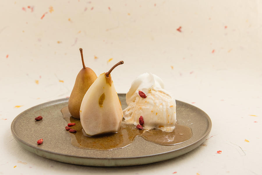 Wine-steamed Durondeau pears, sauce, ice cream and whipped cream and goji. #2 Photograph by Annick Vanderschelden Photography