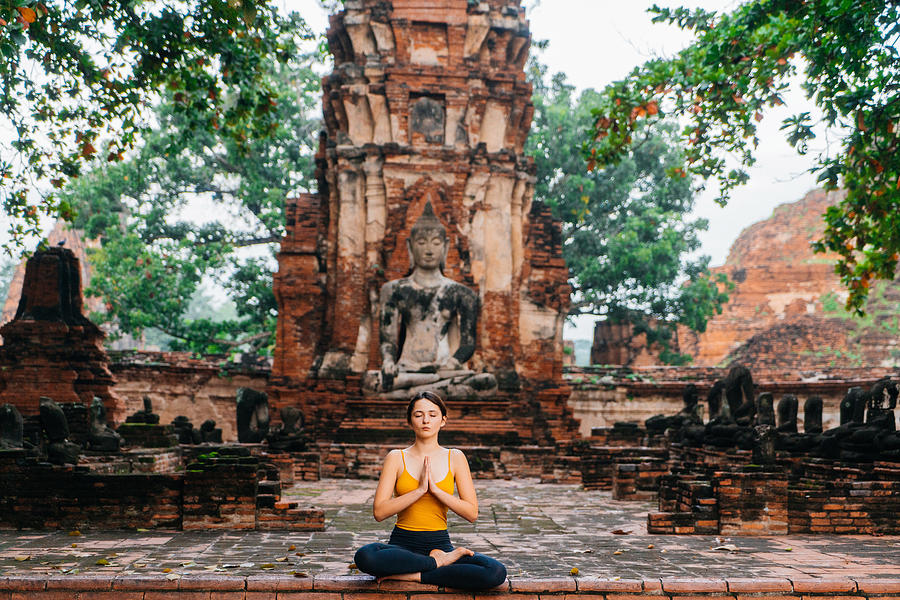 Woman doing yoga near the ruins of Buddhist Temple #2 Photograph by Oleh_Slobodeniuk