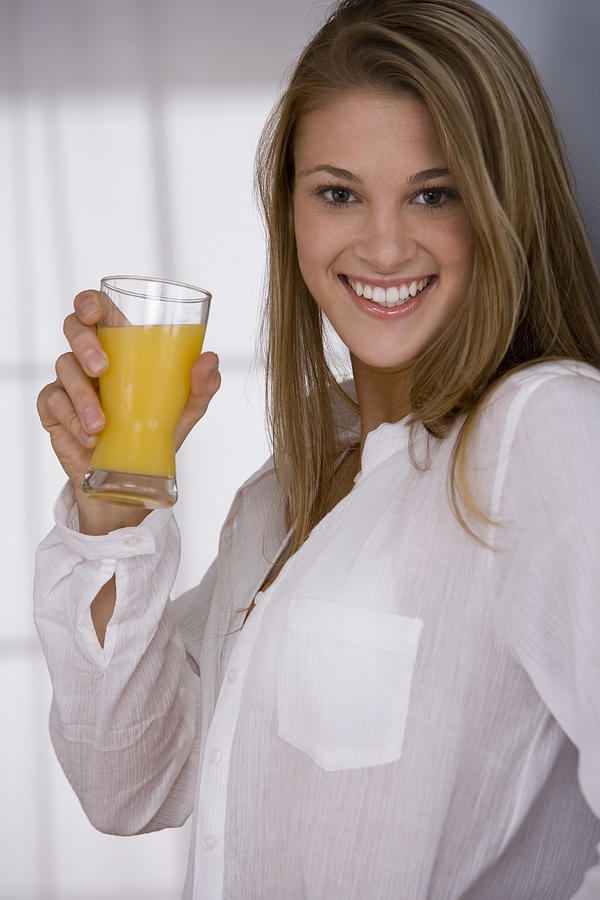 Woman drinking orange juice #2 Photograph by Comstock Images