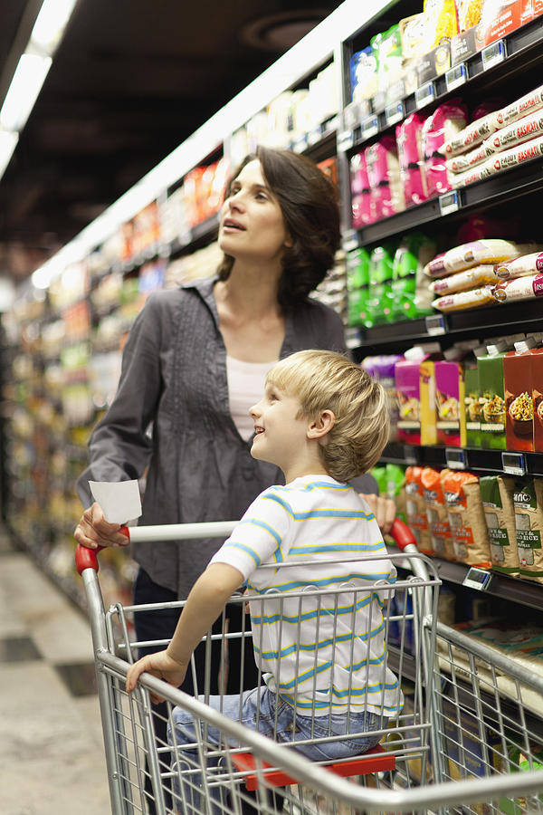 Woman grocery shopping with son #2 Photograph by Hybrid Images
