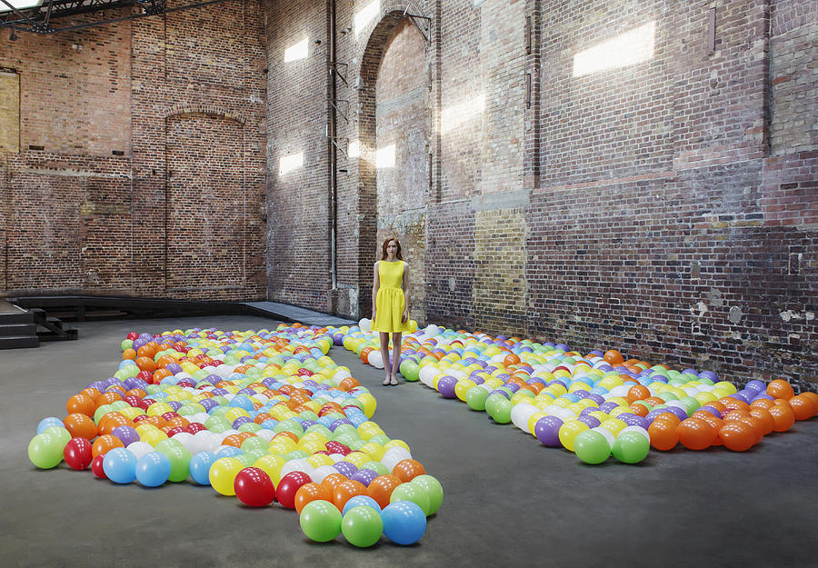 Woman in warehouse with colourful balloons #2 Photograph by Anthony Harvie