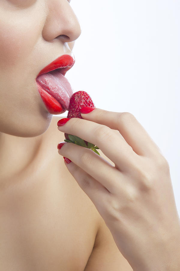 Woman licking a strawberry #2 Photograph by IndiaPix/IndiaPicture