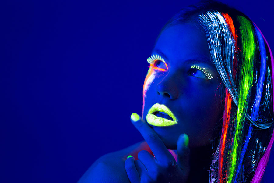Women Portrait with Glowing Multi Colored makeup in black light #2 Photograph by Proxyminder