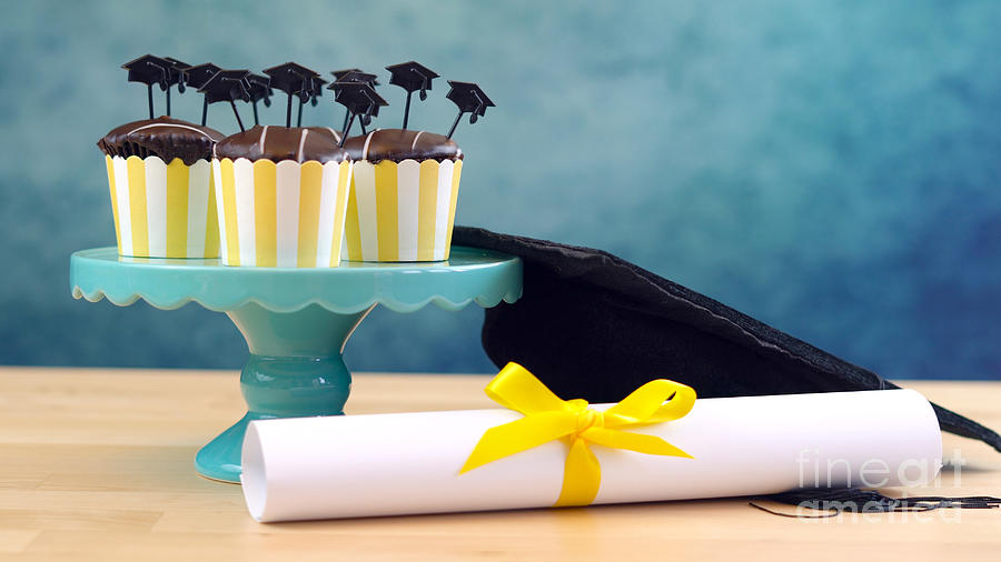 Yellow and blue theme graduation party cupcakes with cap hats toppers. #2 Photograph by Milleflore Images
