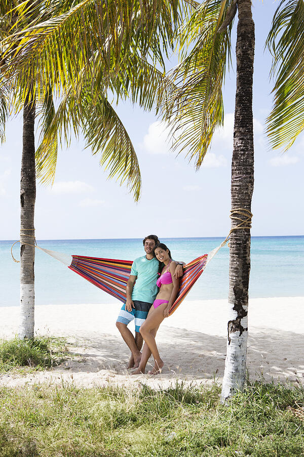 Young couple relaxing in hammock on beach #2 Photograph by Felix Wirth