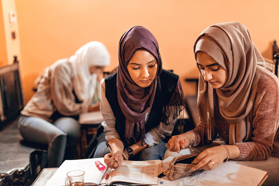 Young muslim women cooperating preparing a school exam #2 Photograph by LeoPatrizi