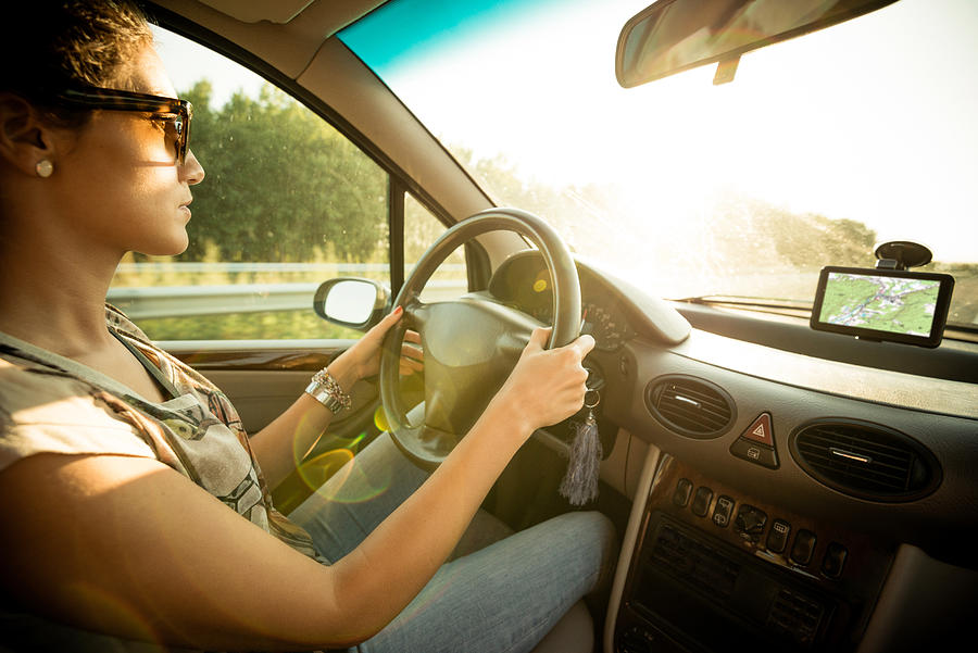 Young woman driving car and speeding on highway in summer #2 Photograph by Drazen_