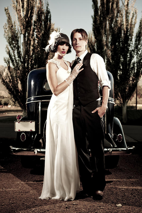 20s Style Couple Standing In Front Of Vintage Car Photograph by Renphoto