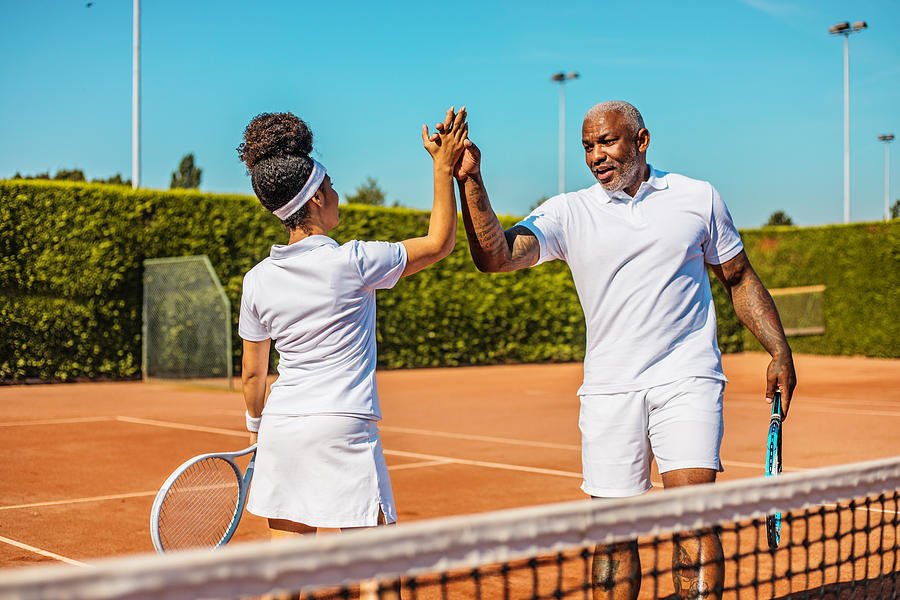 A beautiful black female tennis player on the court with her coach father #3 Photograph by Lorado
