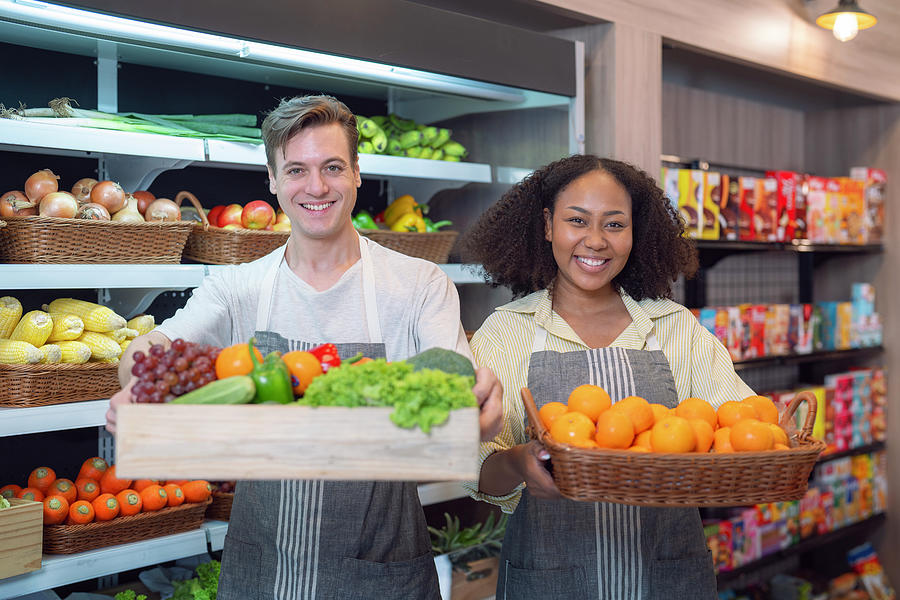 American man grocery working in supermarket with fruit and veget ...