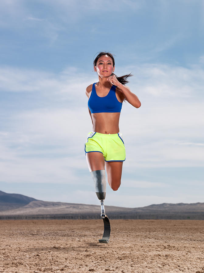 Asian Women With Prosthetic Leg Running In The Desert #3 Photograph by MichaelSvoboda
