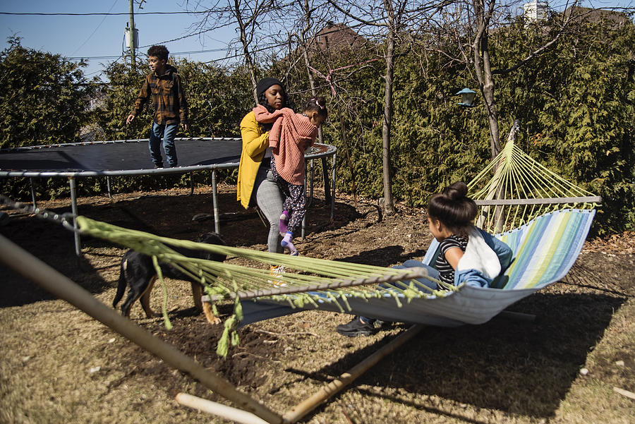 Backyard hangout for mixed-race family in springtime. #3 Photograph by Martinedoucet