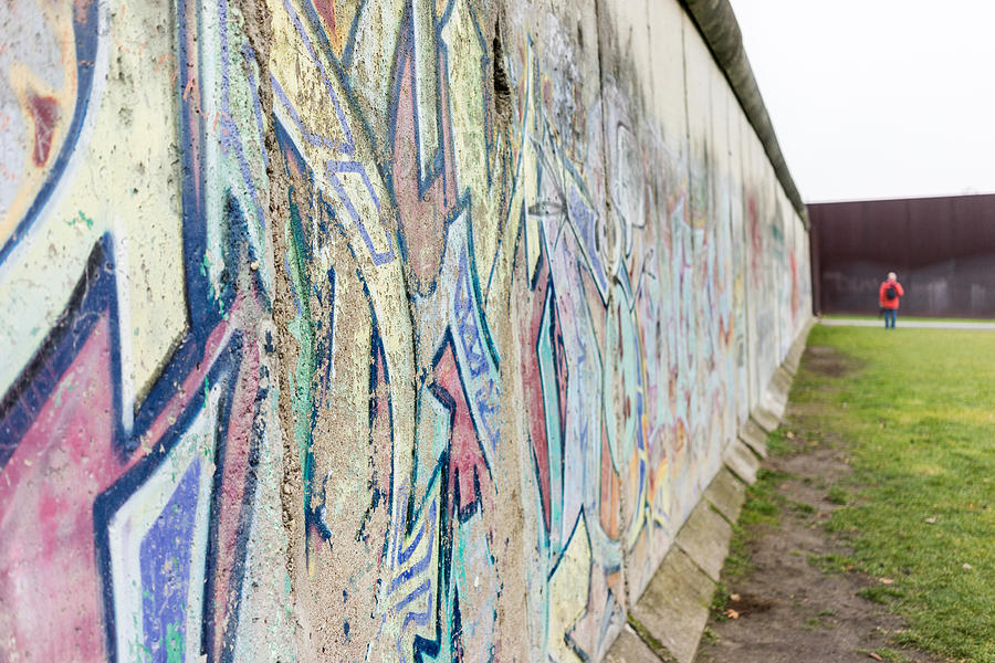 Berlin, Germany - December 20, 2016. Tourists taking pictures at the Berlin Wall memorial in Germany. Writing is visible on the cement wall. Two sides of the wall - East and West Berlin. #3 Photograph by Oleksandra Korobova