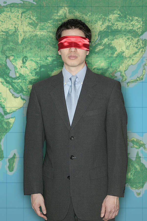 Blindfolded businessman in front of world map #3 Photograph by Comstock Images