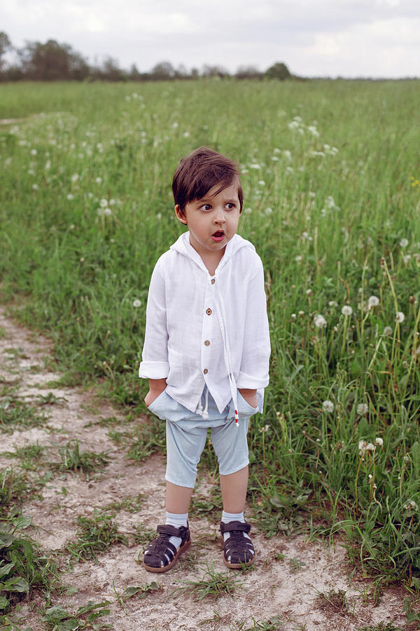 Boy Child In A Green Field In Summer In A White Shirt With A Hood Made ...