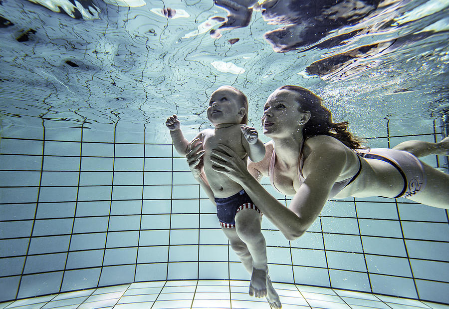 Child learning to swim. #3 Photograph by David Trood