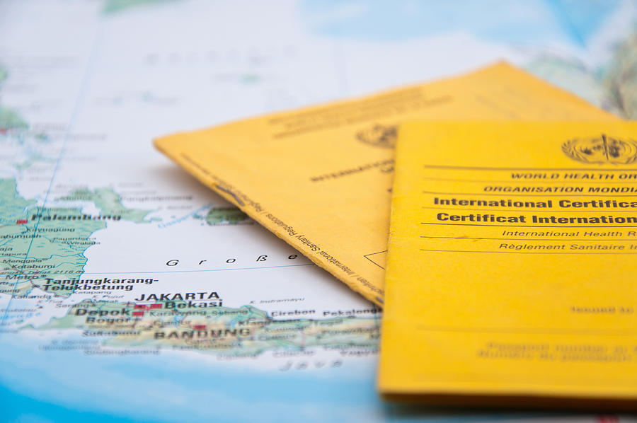 Close Up of Vaccination Certificate and world map. #3 Photograph by Nodramallama