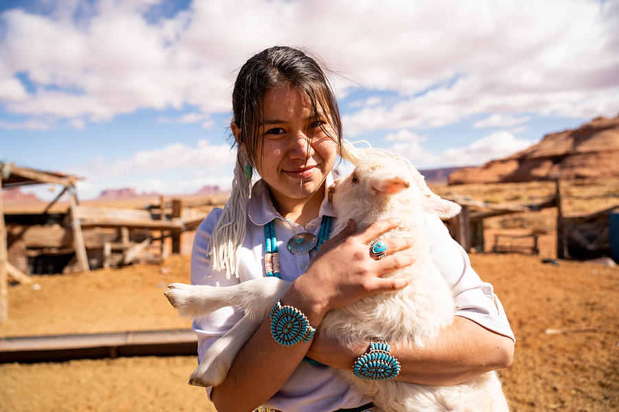 Closeup Of A Young Navajo Woman Holding A Lamb From The Flock #3 Photograph by Grandriver