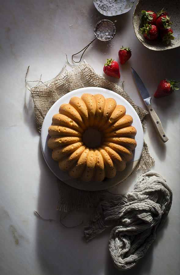 Cream cheese bundt cake on a ceramic plate on a marble table #3 Photograph by The Picture Pantry