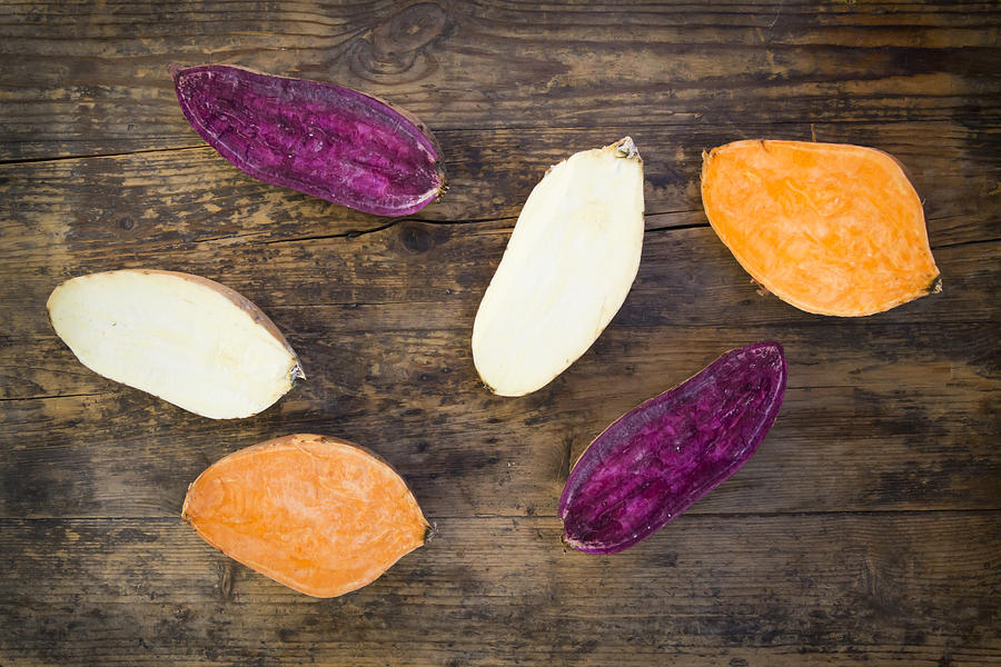 Different Sweet Potatoes On Dark Wood, Cut In Half #3 Photograph by Larissa Veronesi
