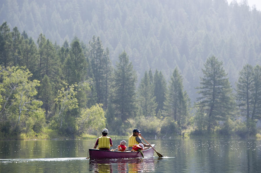 Family canoeing #3 Photograph by Comstock Images