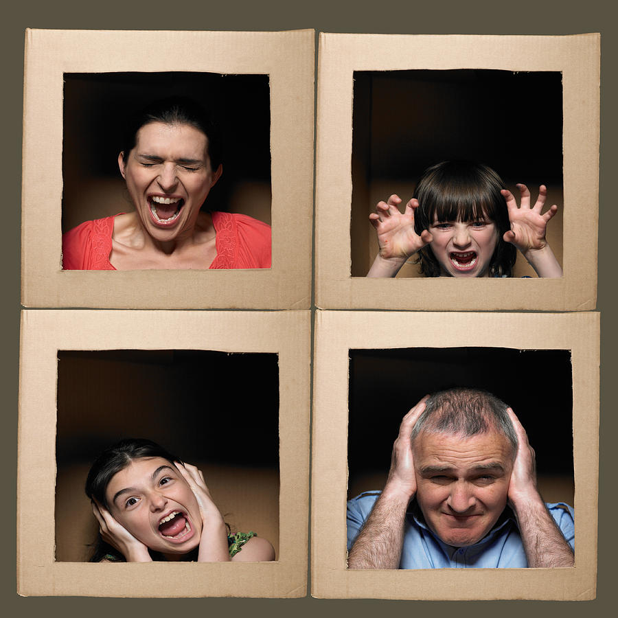 Family with heads in boxes pulling faces #3 Photograph by Michael Blann