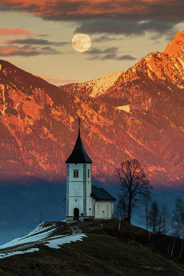Full moon rising over Jamnik church and Storzic at sunset #3 Photograph by Ian Middleton