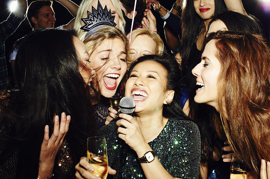 Group of friends having fun on night out. Karaoke. #3 Photograph by Flashpop