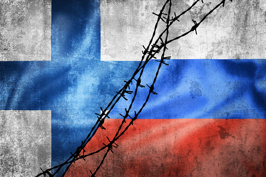 Grunge flags of Russian Federation and Finland divided by barb w ...