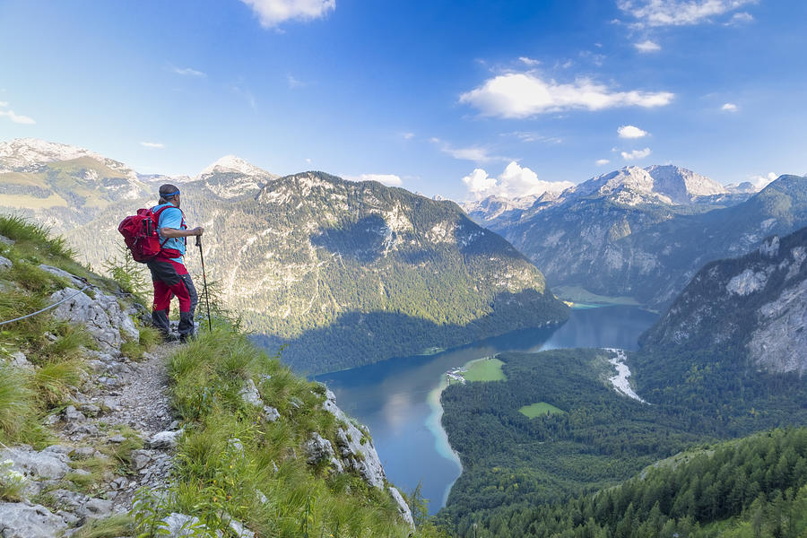 Hiker with view to Lake Königssee and St Bartholomä, Nationalpark Berchtesgaden #3 Photograph by DieterMeyrl