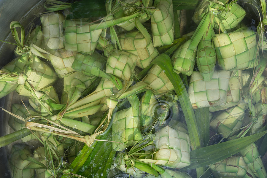 Ketupat, Kupat or Tipat is a type of dumpling made from rice packed inside a diamond-shaped container of woven palm leaf pouch. It is commonly found in Indonesia, Malaysia, Brunei and Singapore. #3 Photograph by Shaifulzamri