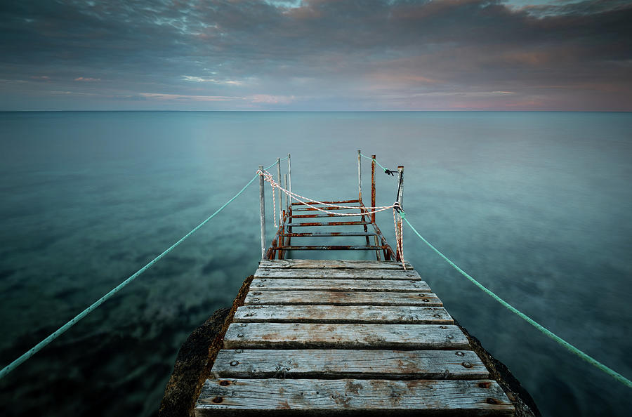 Long wooden pier in the sea at sunset. #3 Photograph by Michalakis Ppalis