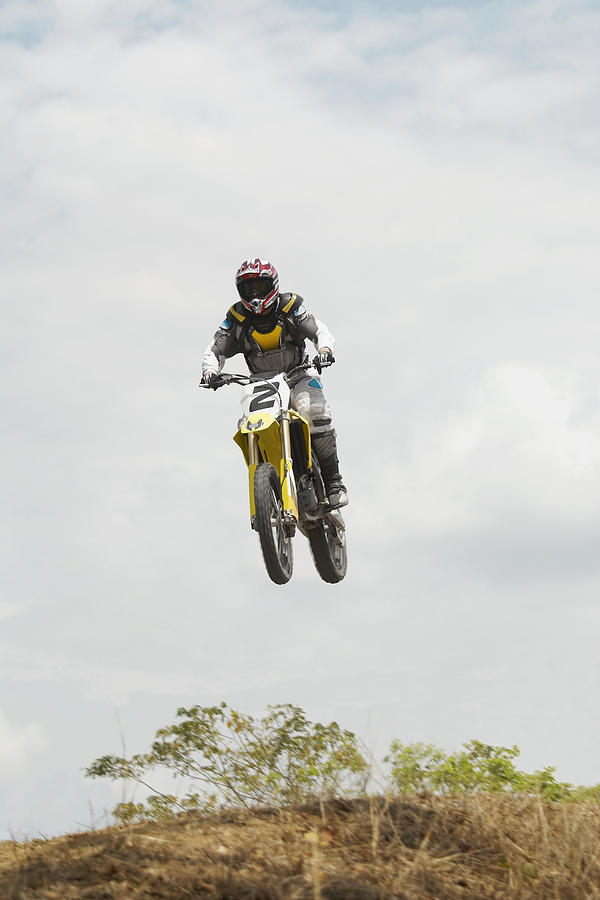 Low angle view of a motocross rider performing a jump on a motorcycle #3 Photograph by Glowimages