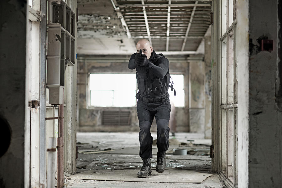 Male military swat team member holding gun in abandoned warehouse #3 Photograph by Lorado