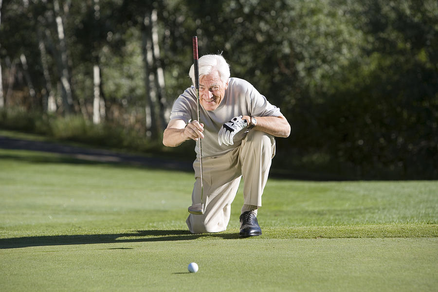 Man playing golf #3 Photograph by Comstock Images