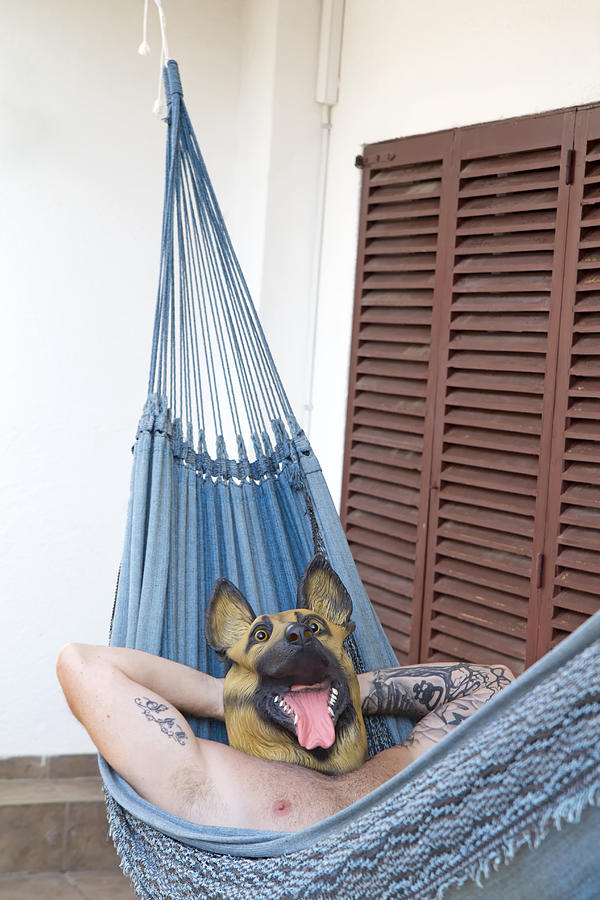 Man with dog mask resting in a hammock #3 Photograph by Fernando Trabanco Fotografía