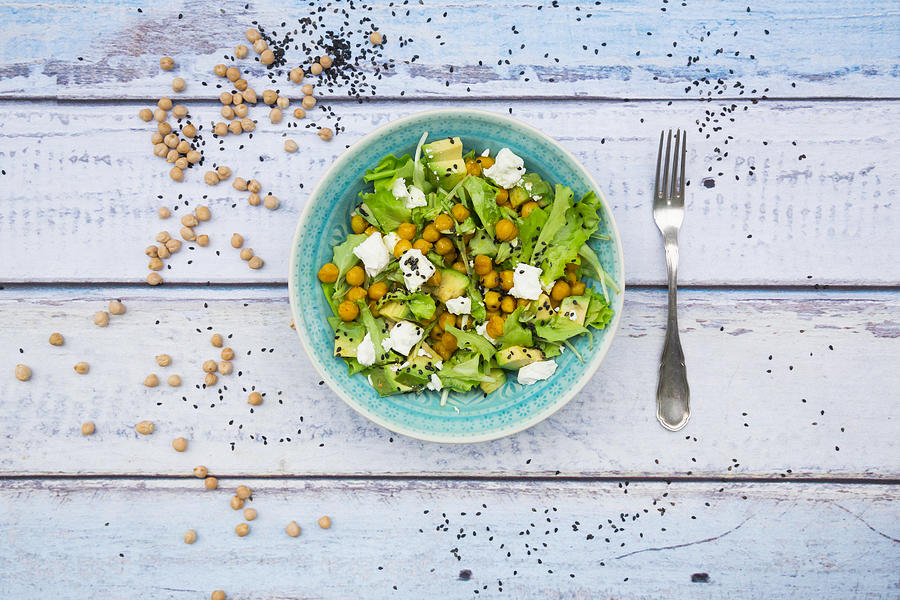 Mixed raw salad with roasted chickpeas, feta cheese, avocado and black sesame on plate #3 Photograph by Larissa Veronesi
