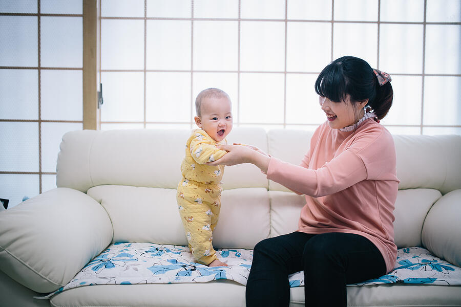 Mother and baby playing in living room #3 Photograph by Insung Jeon