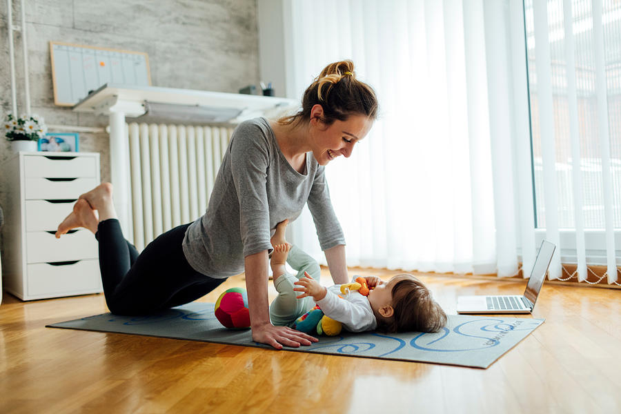 Mother Exercise With Her Baby At Home #3 Photograph by Vgajic