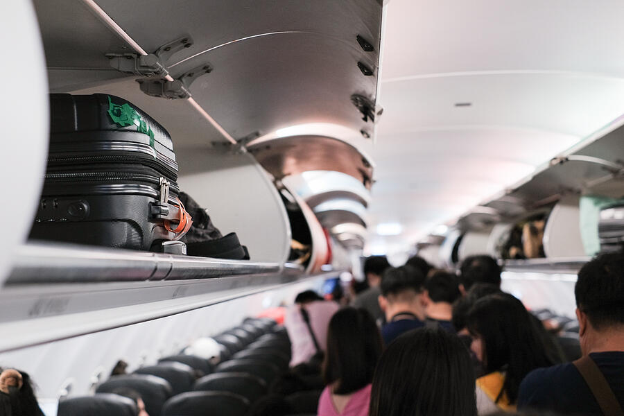 overhead locker on airplane,Passenger put cabin bag cabin on the top shelf. Travel concept #3 Photograph by Jackyenjoyphotography