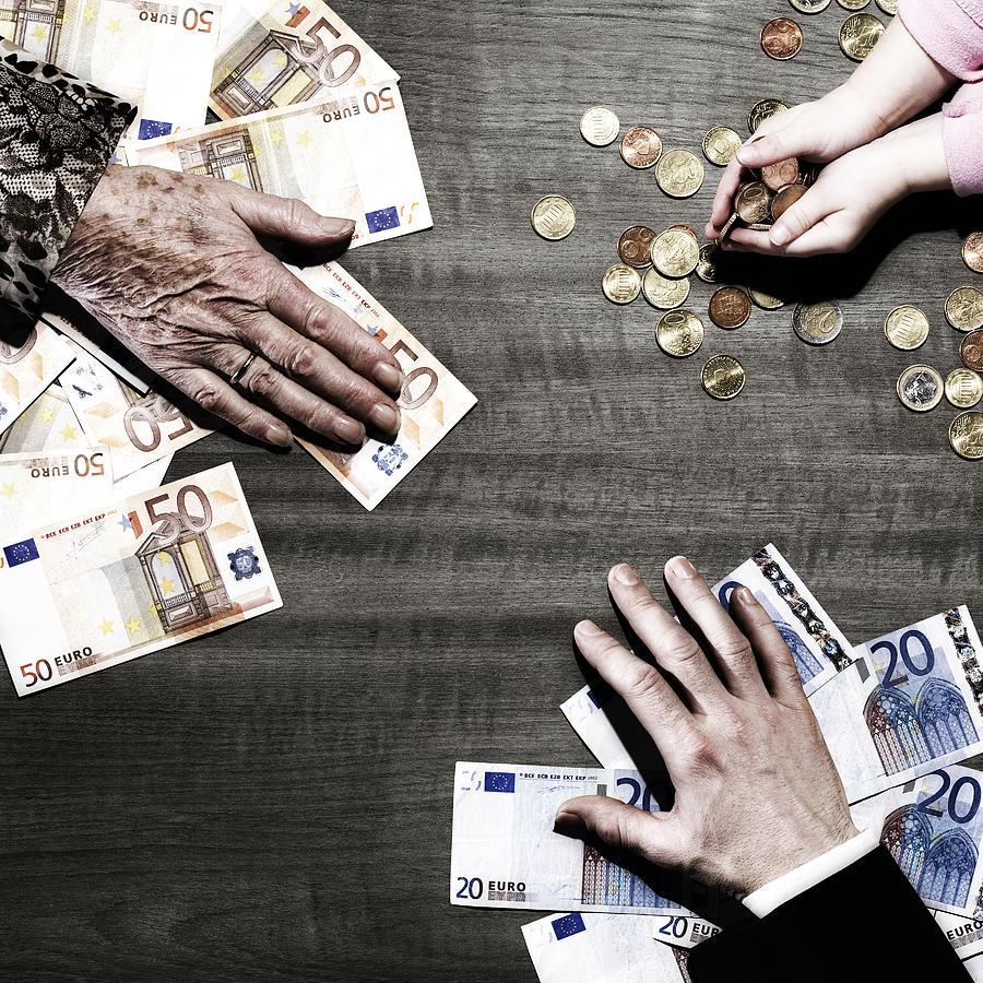 3 Peoples Hands With Money On Table Photograph by Maarten Wouters